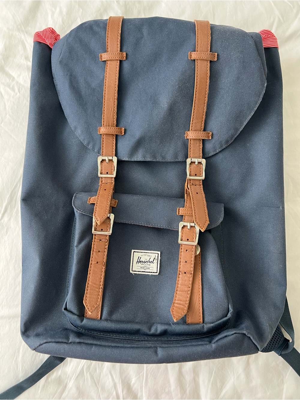 Herschel Supply Company navy backpack with brown straps and red accents